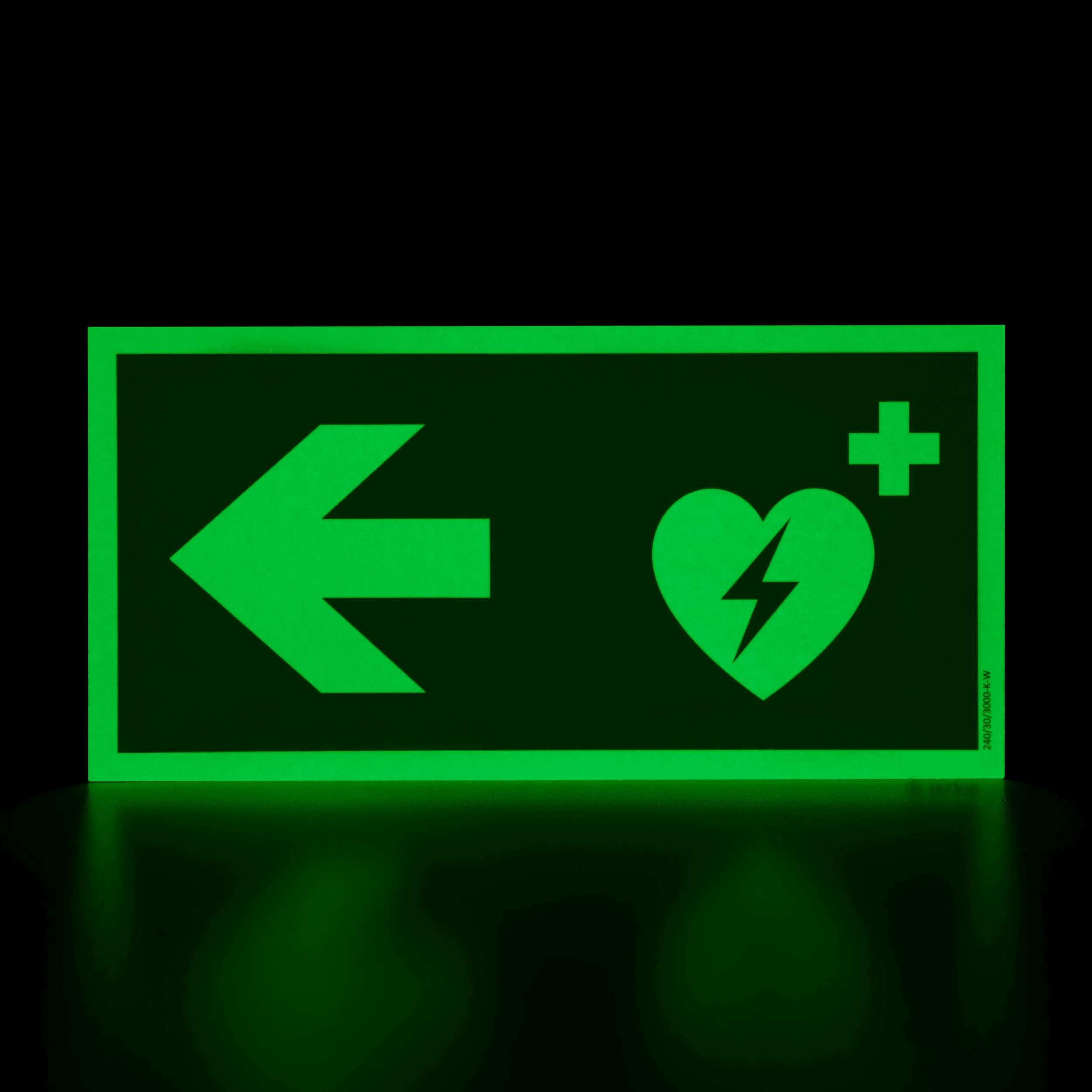 defibrillator hinweisschild mit pfeil nach links photolumineszierend, langnachleuchtend leuchtend